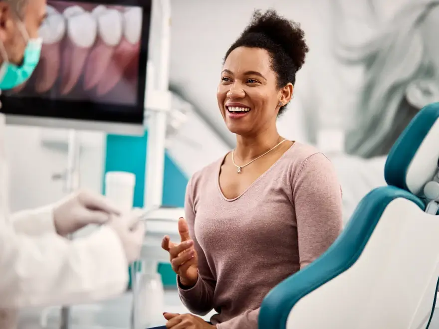 A smiling patient in the dental chair during an exam