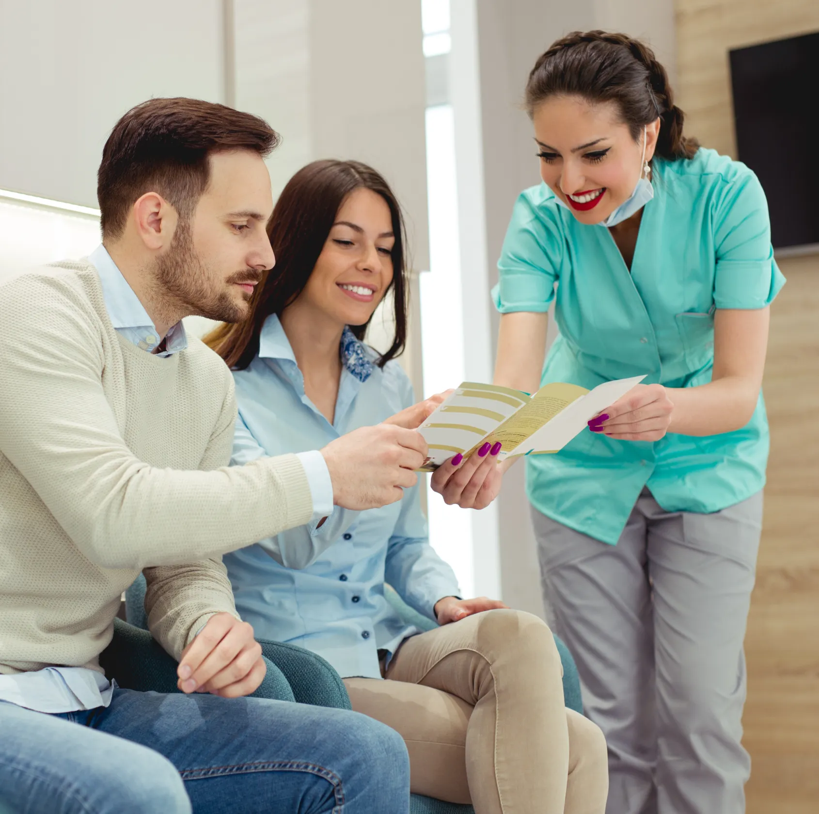 A couple reviewing payment options with a team member