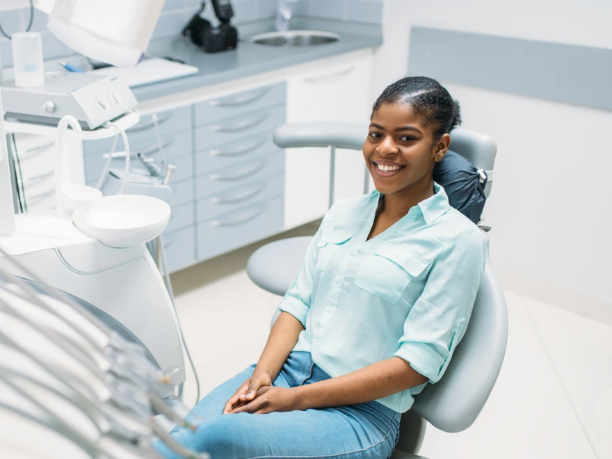 A smiling teen seated in the dental chair