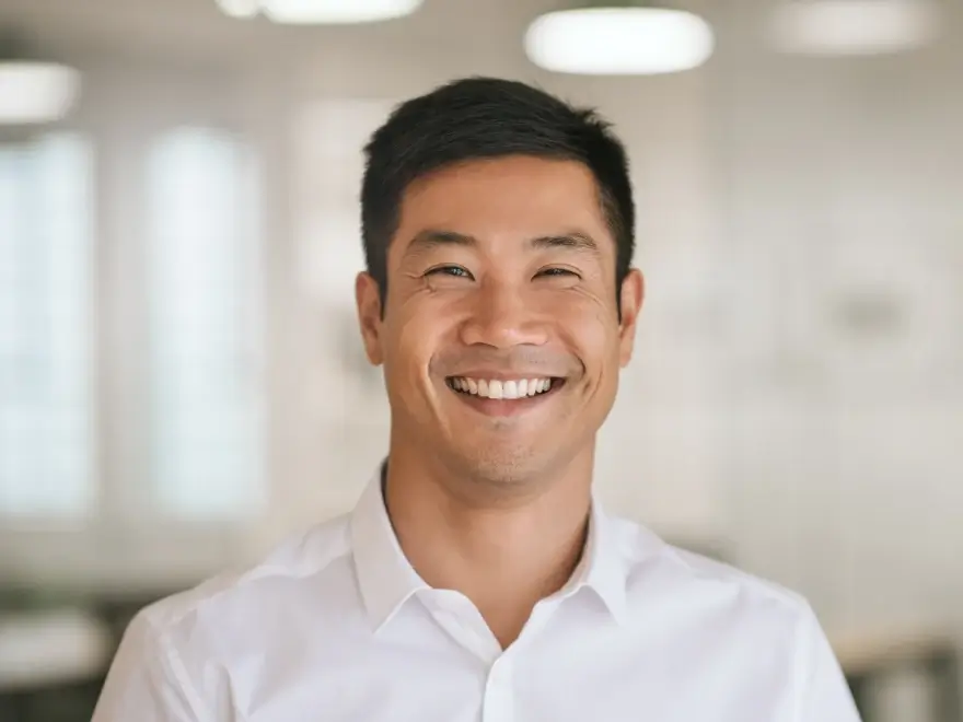 A smiling man in a white shirt