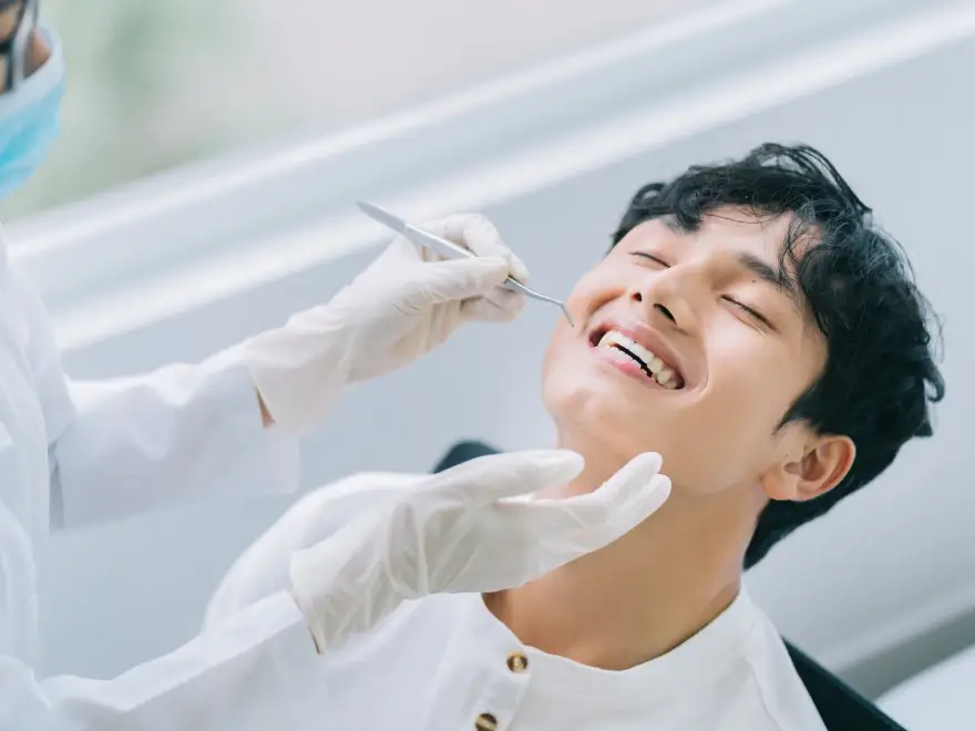 A young man smiling during a dental exam