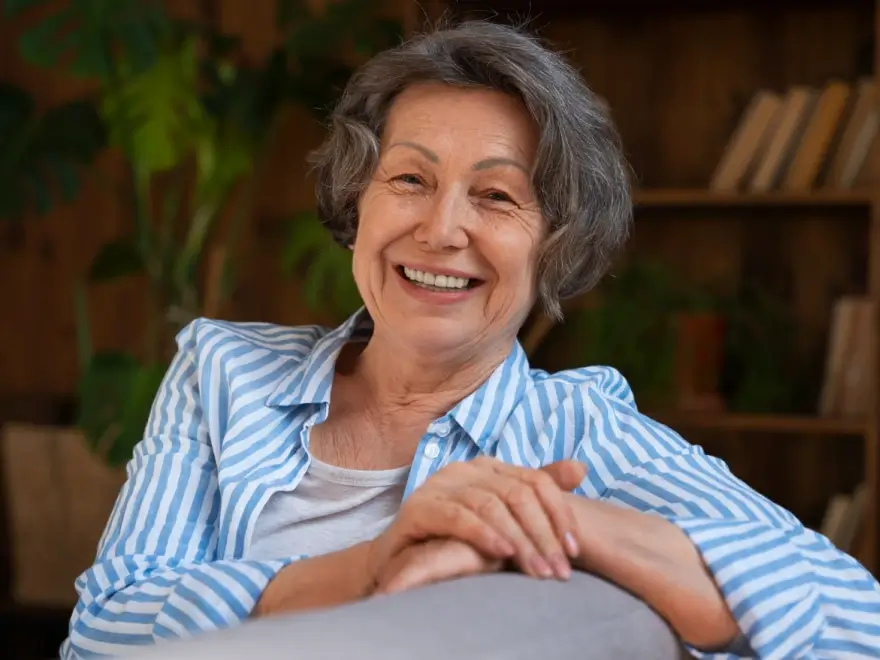A smiling older woman with grey hair