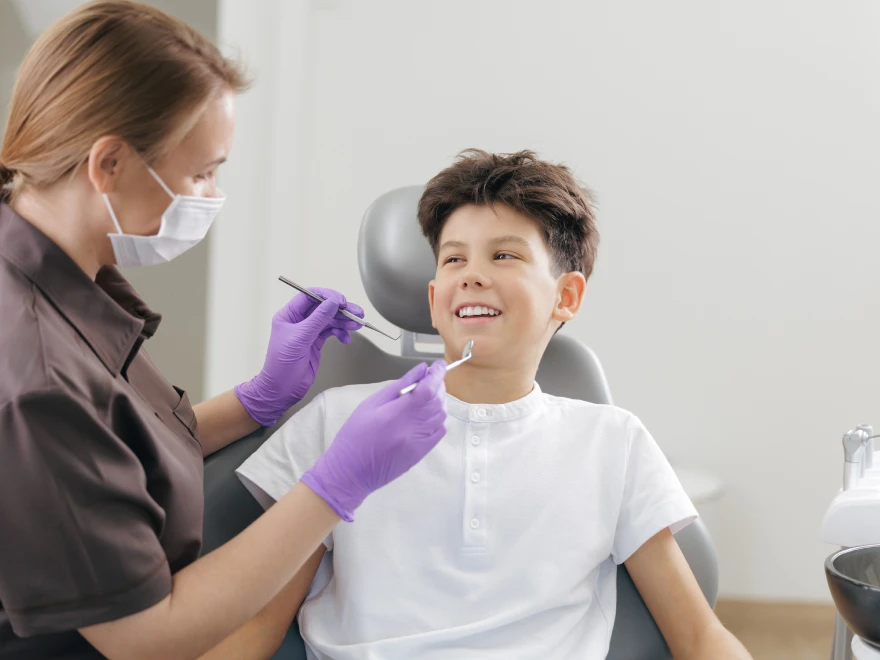 A boy smiling during a dental exam