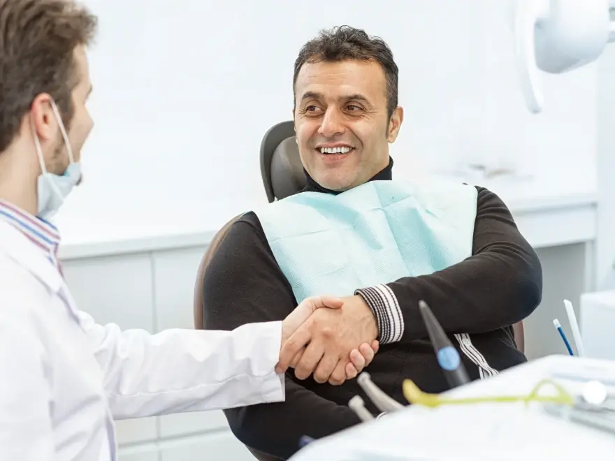 A patient shaking hands with his dentist
